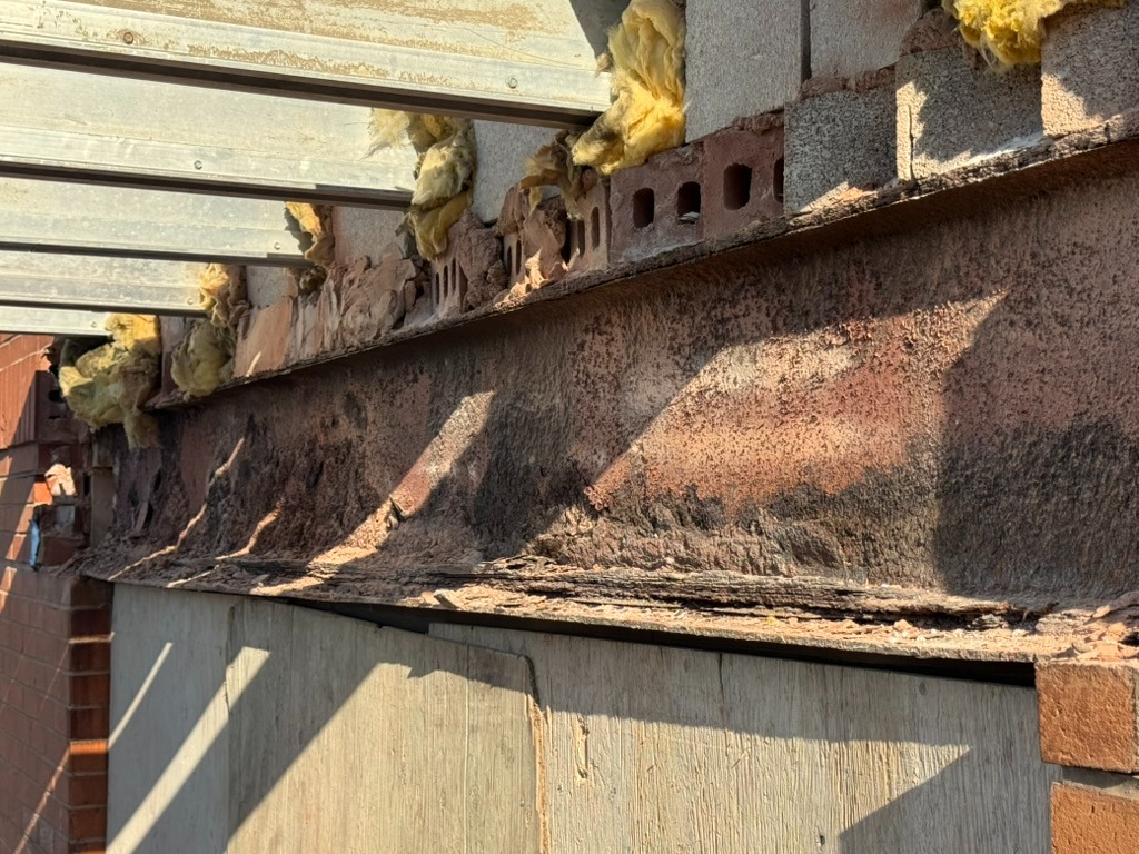 Corroded steel lintel and shelf angle exposed during restoration